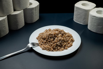Buckwheat plate on a background of toilet paper