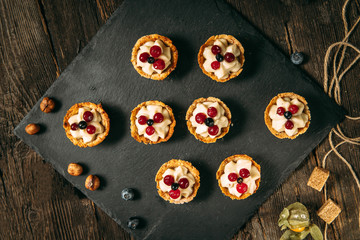 Sweet dessert baskets with cream and berries