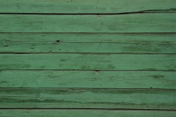 Obraz premium Wooden boards are painted with green paint.