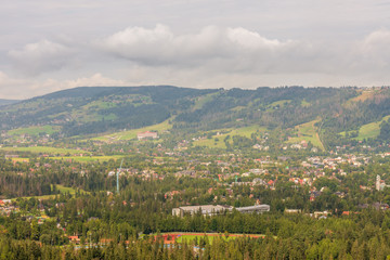 Fototapeta premium Village in the mountains. Lots of trees and greenery