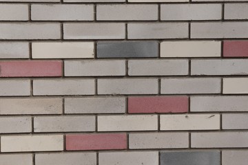 Brickwork of gray and burgundy colors.