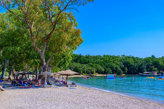 Dassia Beach with crystal clear azure water in beautiful landscape scnery - paradise coastline of Corfu island, Ionian archipelago, Greece.