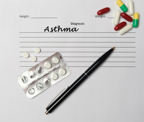Asthma diagnosis written on a white piece of paper.