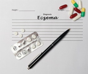 Eczema diagnosis written on a white piece of paper.