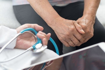 Geriatric doctor or geriatrician healthcare concept. Doctor physician hand with woman elderly senior patient in hospital health examination room or hospice nursing home or wellbeing county.