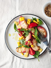 Salad with grilled peaches, corn,  tomatoes and basil.