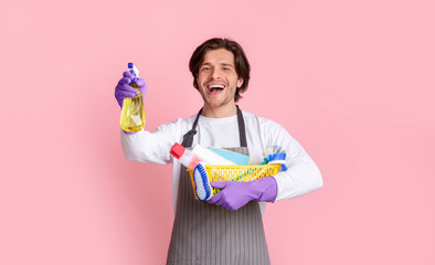 Portrait Of Excited Man With Bucket Of Cleaning Supplies In Hands