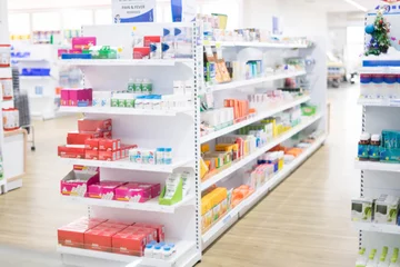 Stof per meter At the chemist, Medicines arranged on shelves, Pharmacy drugstore retail Interior blur abstract background with medicine healthcare product on cabinet with warm light. © kamol