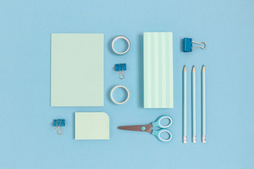 Layout of stationery on a blue pastel background. Monochrome school concept.