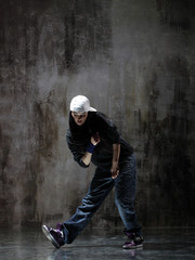 Young beautiful dancer is posing in studio