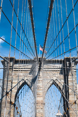 Brooklyn Bridge New York City close up architectural detail with American flag 