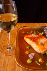 cooked fried fish on a plate with vegetables