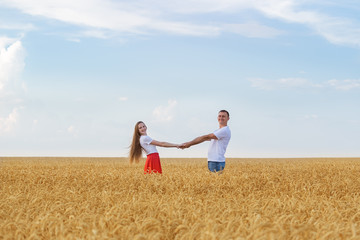 Couple enjoying outdoors in wheat field. Countryside romance