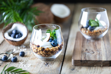 Diet dessert with yogurt, granola and fresh berries, close-up, horizontal. Healthy breakfast ingredients.
