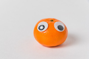 Cute Mandarin with big Googly eyes on white background. tangerine character