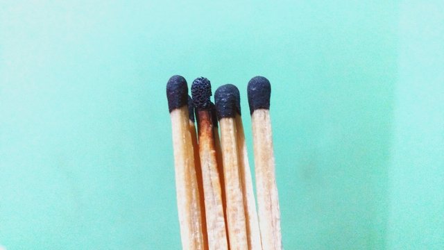 Close-up Of Matchsticks Against Wall