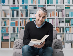 Man relaxing and reading a book