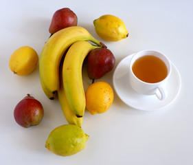Cup of tea and fruits on a white background. Beautiful composition.