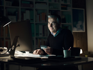 Man doing online shopping late at night