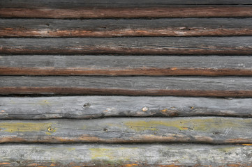 Brown old log wall. Wooden decrepit texture