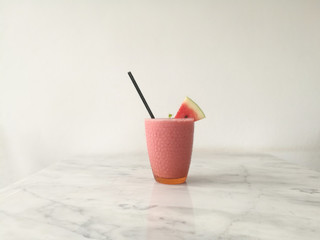 Drink scene of water melon smoothie on Striped marble Table and white Texture background