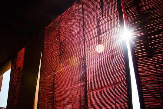 sunlight shinning through window with red curtains