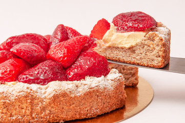 Slice of strawberries tart with yellow pudding