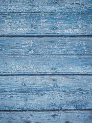 Old wooden boards painted with blue paint. Old blue cracked paint. Old blue wooden wall.