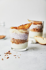 Useful breakfast with granola, yogurt and chia seeds on a bright background