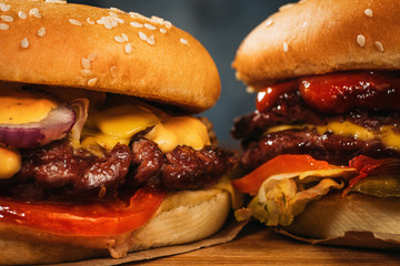 Two big homemade burgers or hamburgers with big roasted meat, close up.