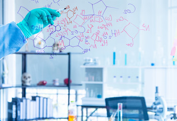 The scientists, chemists, researcher discover the chemical formula write on whiteboard in...