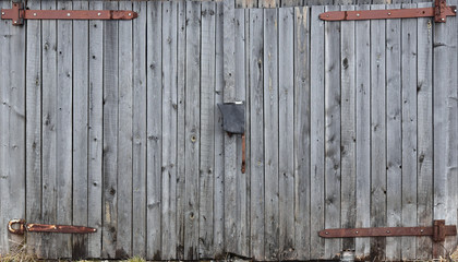 Gray wooden double door, old garage door, taupe boards