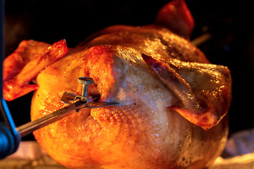 Grilled chicken in the oven. Roast poultry on a spit. Home cooking. Crisp.