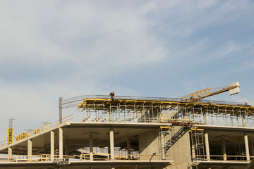 the process of building a multi-story building. Crane and builders.