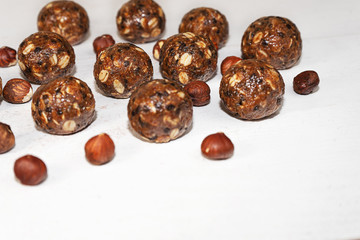 Energy balls with oat, chocolate and nuts on gray wood background.