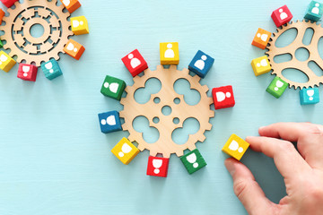 image of colorful blocks with people icons over wooden table ,human resources and management concept