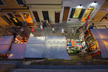 Night view from above of a colorful street market on an alley de Menorca in Spain.