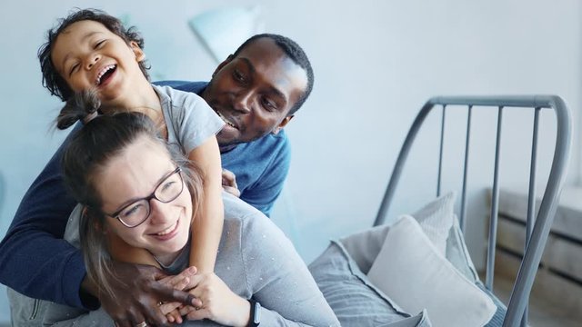 Happy young family, parents and baby son, mixed race