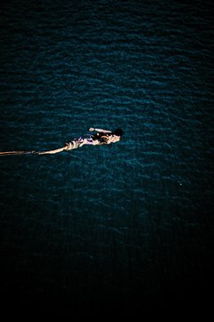 High Angle View Of Person Bungee Jumping Over Sea