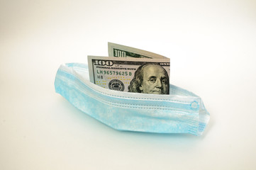 medical mask in the form of a boat with money inside