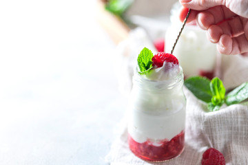 Fermented drink kefir, yogurt in a glass jar on a light background. Probiotic cold fermented dairy drink.
