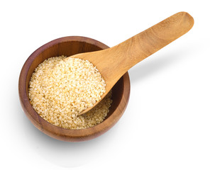 Top view of cereal dried food whole grains with white sesame seeds in wooden spoon on bowl isolated on white background.