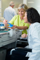woman training disabled trainee in medical lab