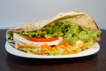 Healthy bread sandwich with salad. Tomato, lettuce, cheese, carrot.