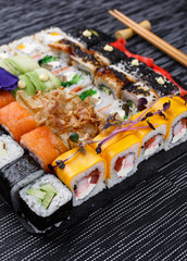Sushi roll japanese food in restaurant. Different types of sushi roll set with salmon, vegetables, fish