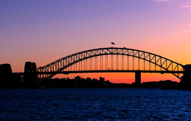 Fototapeta na wymiar Panoramic view of Sydney Harbour with all the vibrant colours on a orange and blue sunset afternoon 