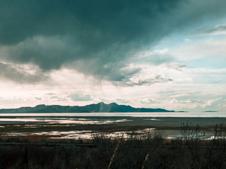 Rain storm over distant mountain