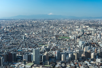 Naklejka premium Mountain Fuji with cityscape of Tokyo and skylines. Taken from Tokyo metropolitan government building. Japan travel landmark.