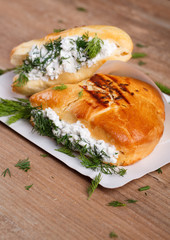 Achma - khachapuri with cheese and dill on a wooden table. Traditional Georgian cuisine.