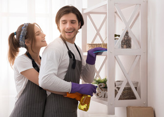Young Romantic Couple Doing Housework At Home Together, Hugging And Smiling